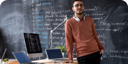 portrait-bearded-arabian-software-developer-with-wireless-headphones-around-neck-standing-desk-with-computers-office